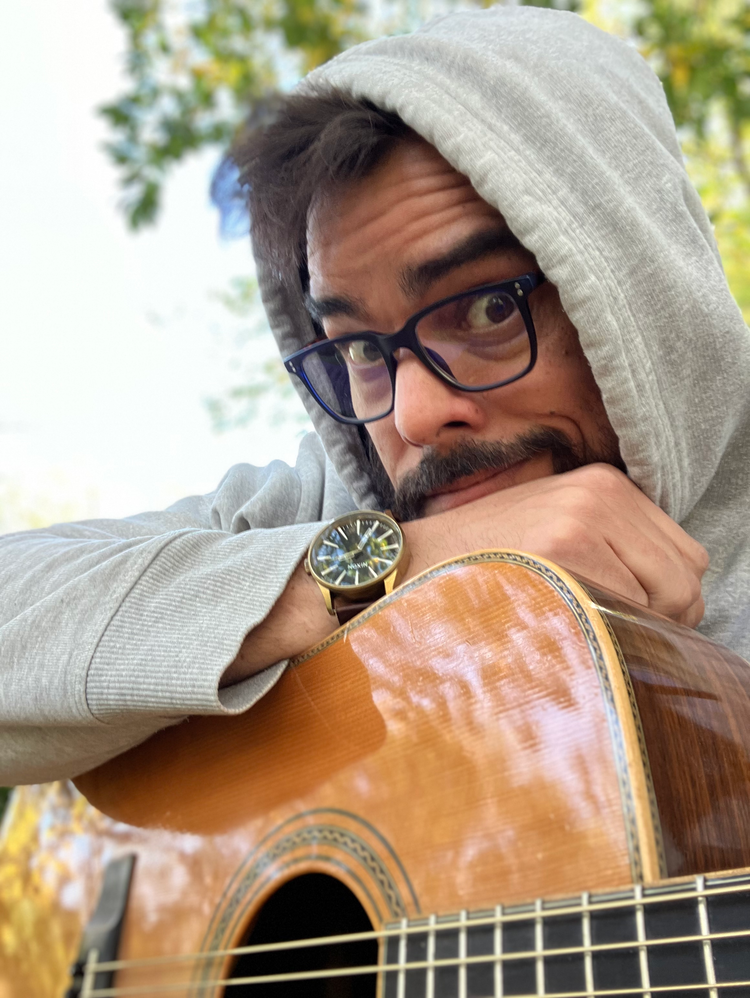 Sonovor Reclaims the Artist: Clarity, Craft, and Consequence - Ben Beveridge looking over his guitar. 